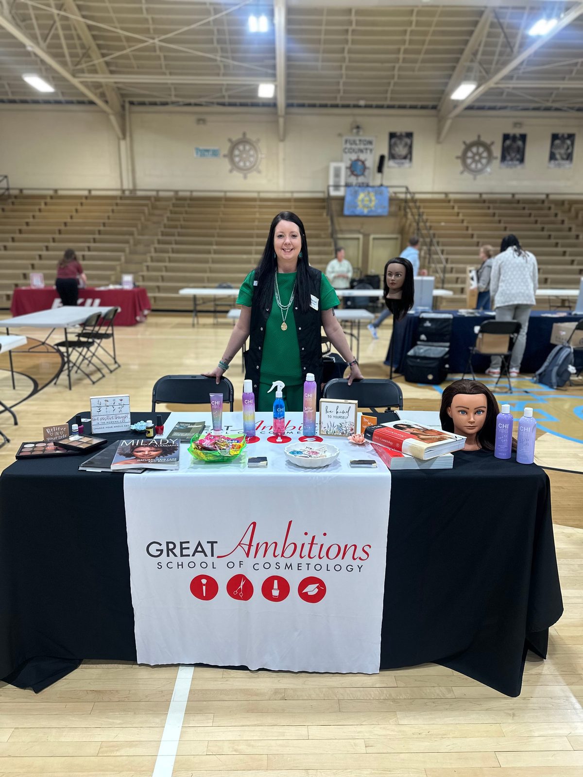 Amanda Morris representing Great Ambitions School of Cosmetology at a community expo booth