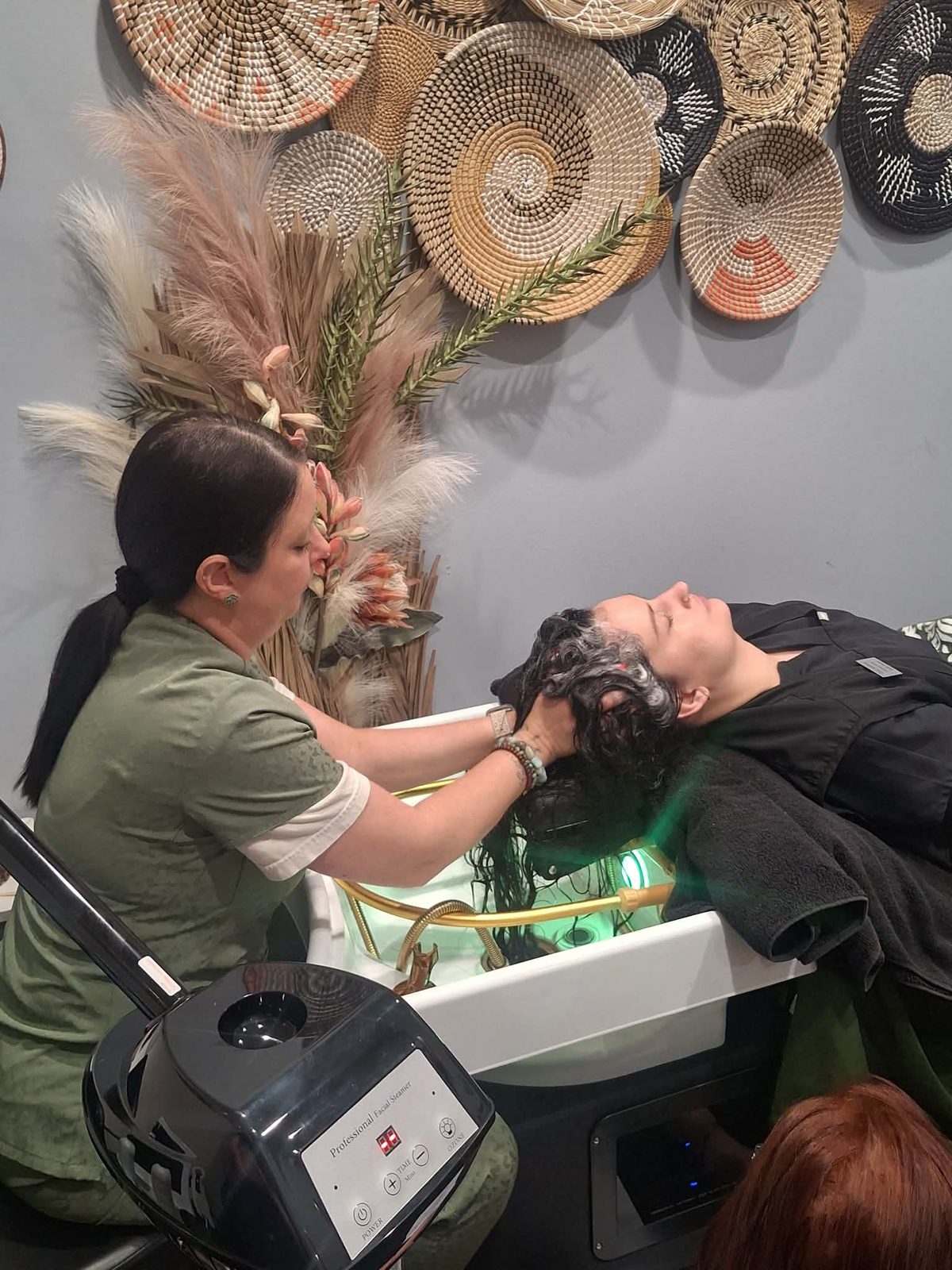 A Great Ambitions student practicing a hair treatment technique
